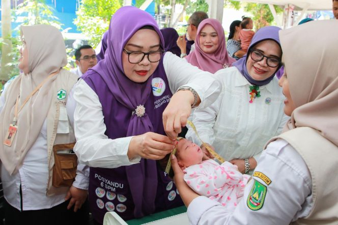 
					Pembina Posyandu Kota Batam, Erlita Amsakar, melayani balita saat peringatan Hari Posyandu Nasional 2026 yang digelar di Kecamatan Sekupang dan Kecamatan Lubukbaja, Rabu (28/4/2026).